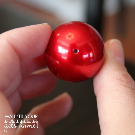 red bead with a hole in the top