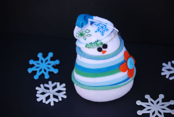 Do you want to build a snowman? Forget the snow, and grab some socks to create an adorable sock snowman instead! {Christmas kids craft or Winter decor? You choose!} OneCreativeMommy.com