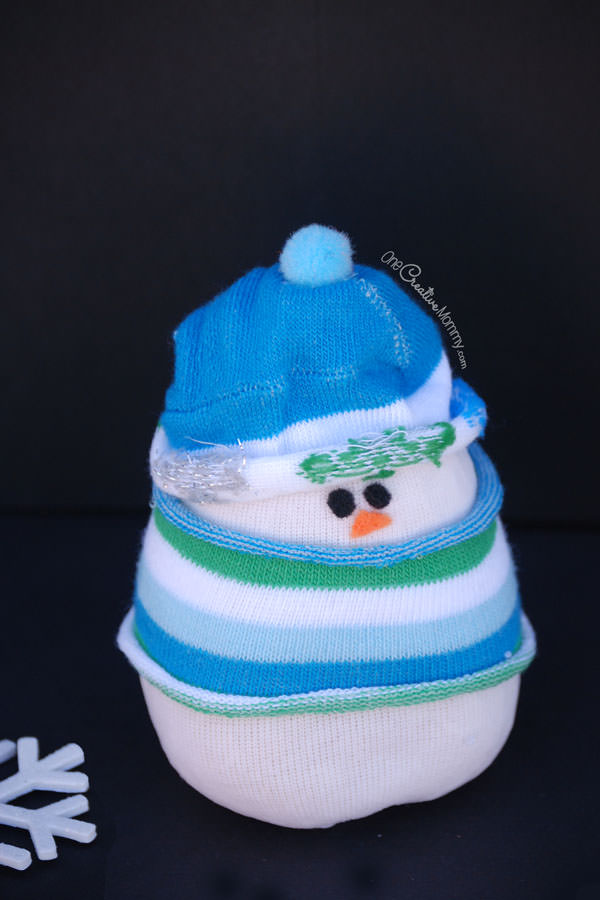 Do you want to build a snowman? Forget the snow, and grab some socks to create an adorable sock snowman instead! {Christmas kids craft or Winter decor? You choose!} OneCreativeMommy.com