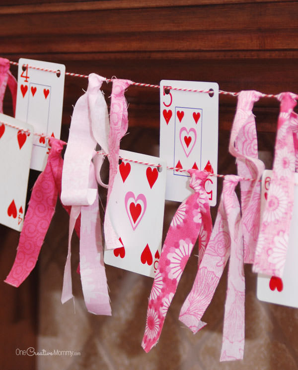 Looking for a quick and easy Valentine decor idea?  All you need for this fun Valentine's Day banner is a deck of playing cards, scrap fabric, and baker's twine.  {Simple tutorial from OneCreativeMommy.com}