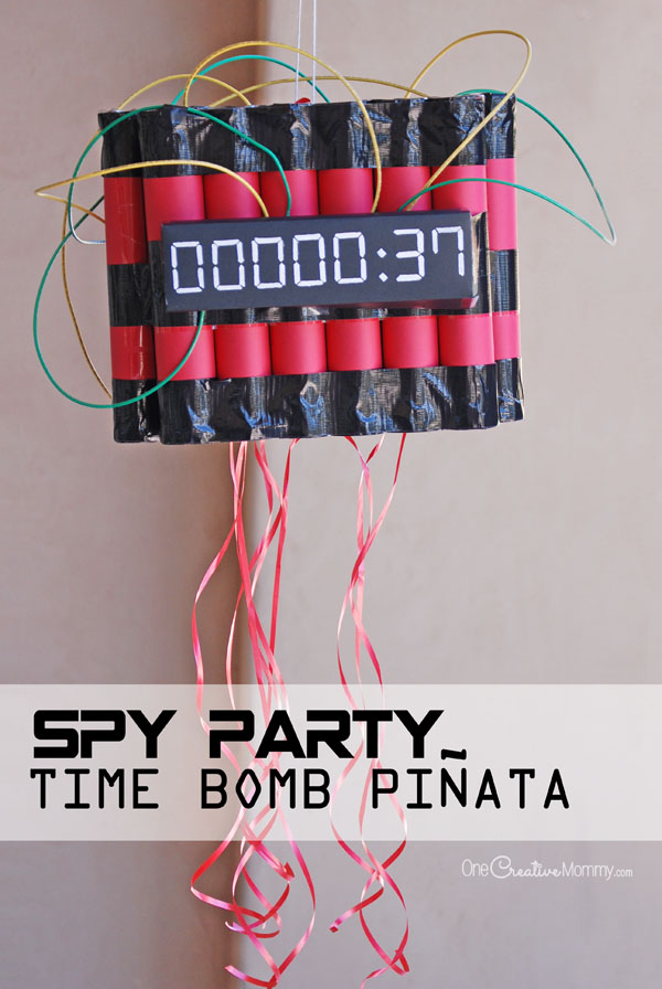 The perfect way to end a Spy Birthday Party! Kids have to disarm the time bomb piñata by pulling on the strings. {OneCreativeMommy.com}