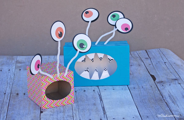 Check out these super fun and easy Monster Valentine Boxes! Can you tell what they are made out of? {OneCreativeMommy.com} Such a cute Valentine's day craft idea. Free printable eyeballs with Silhouette cutting file, too.