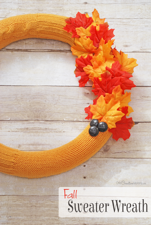 Give a pool noodle a warm makeover with this cozy Fall wreath idea. {OneCreativeMommy.com} Pool noodle wreath | Sweater makeover