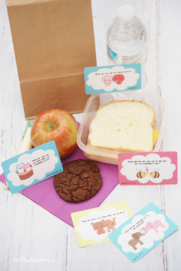 Cheer up your kids' lunch box with these clever and adorable Valentine Lunch Box jokes! Free printables {OneCreativeMommy.com} #valentine #valentinejokes #lunchboxjokes #lunchboxlovenotes #valentinesday #schoollunch