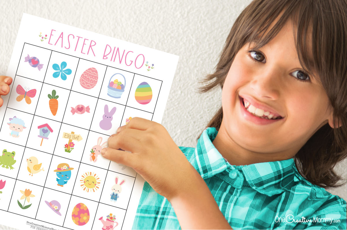 Image of a young boy proudly holding up an Easter bingo game board.