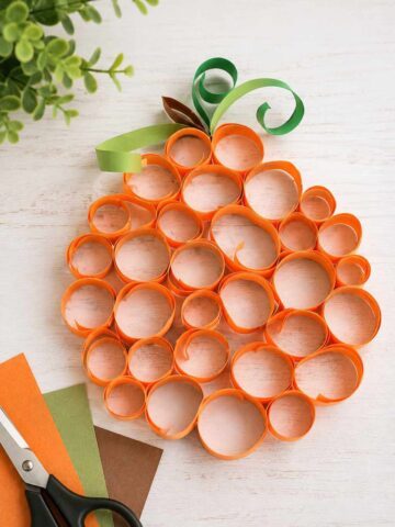 Easy rolled paper pumpkin craft made with orange paper strips