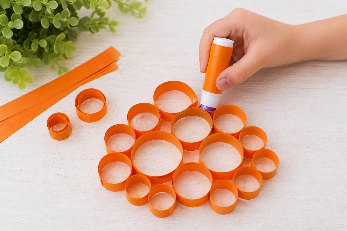 Rolled paper circles glued together to form a pumpkin