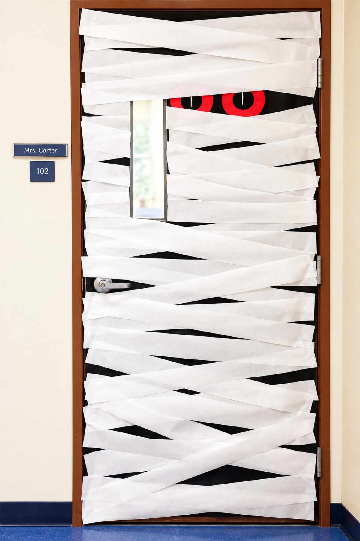 Spooky Students classroom Halloween door decorated with ghosts and caution tape