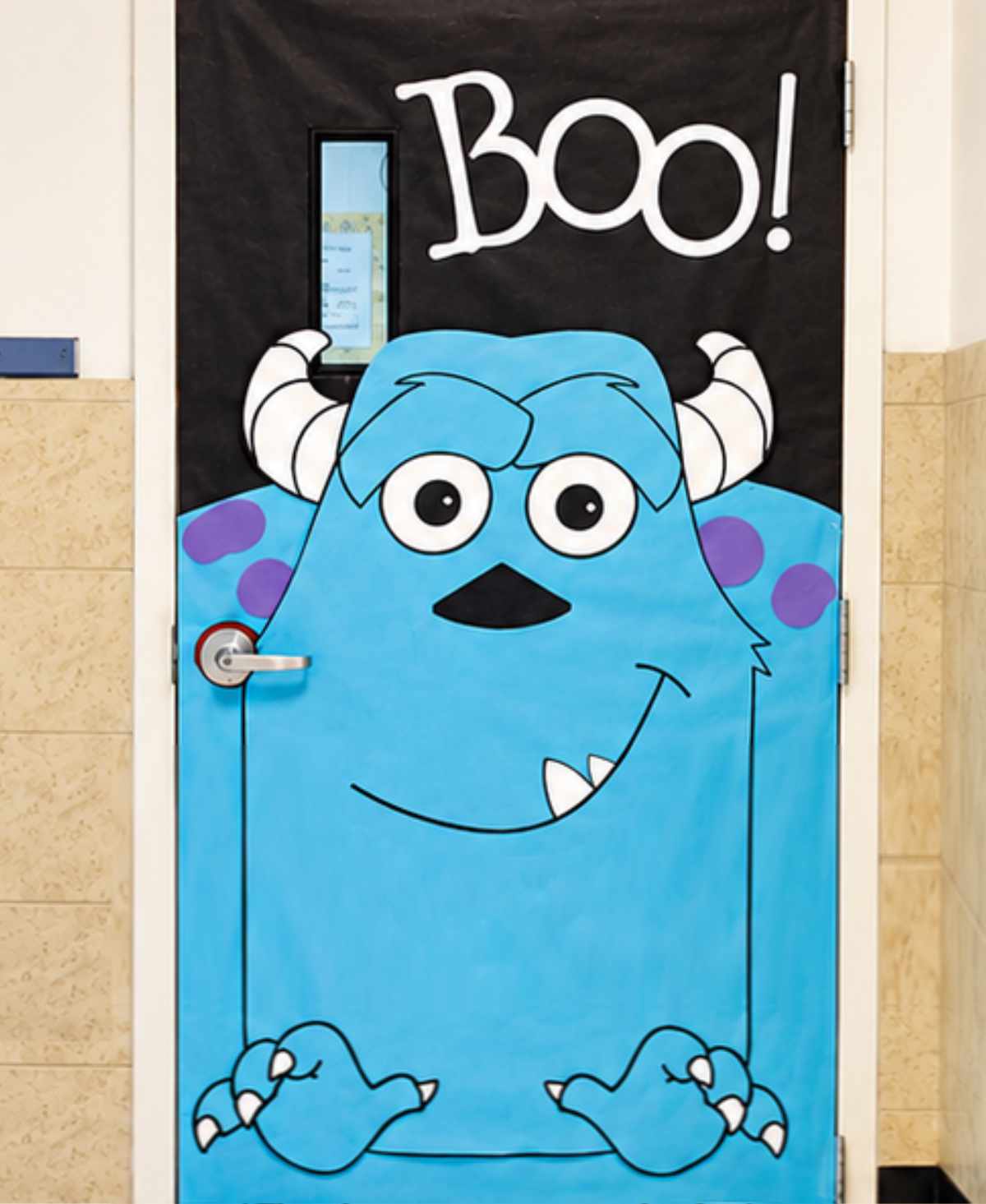 Blue monster Halloween classroom door decoration with horns and Boo sign