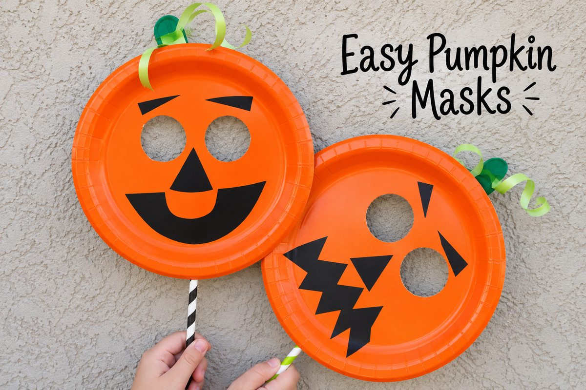 wo homemade orange paper plate pumpkin masks with smiling and spooky jack-o'-lantern faces, green ribbon stems, and striped handles.